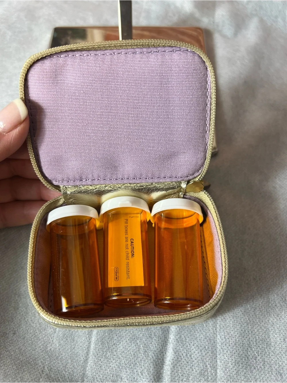 Coach Poppy Signature travel pill case features a whimsical pink graphic 💖
